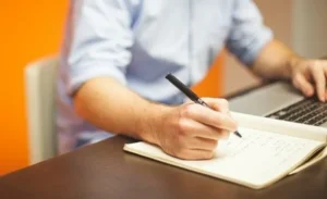 A teacher writing down his notes