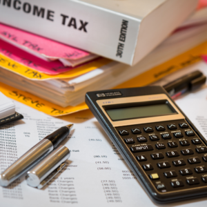 Accounting stationery including income tax books, a calculator, and pen