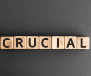wooden blocks spelling the word crucial