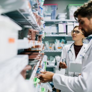 A pharmacist assistant in a room with a pharmacist